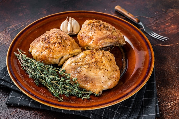 Roasted chicken thighs with spices in a plate.   Top View.