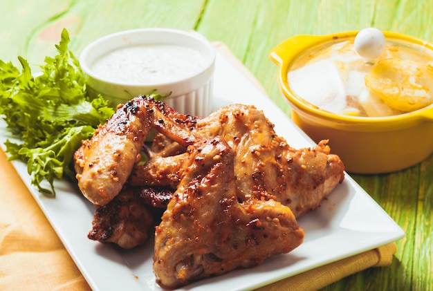 Roasted Chicken wings and tzatziki sauce on a plate