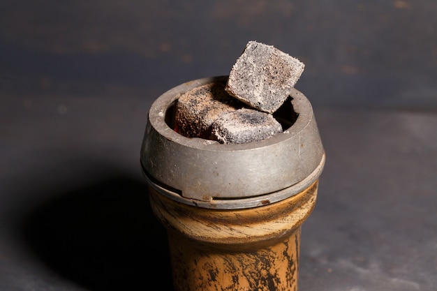 Roasted coals in a clay bowl for a hookah