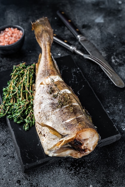 Roasted cod white fish with thyme on marble board