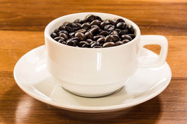 Roasted coffee bean in white coffee cup