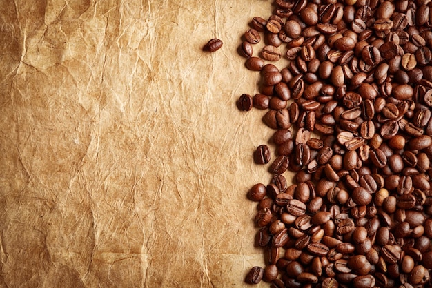 Roasted coffee beans on antique paper