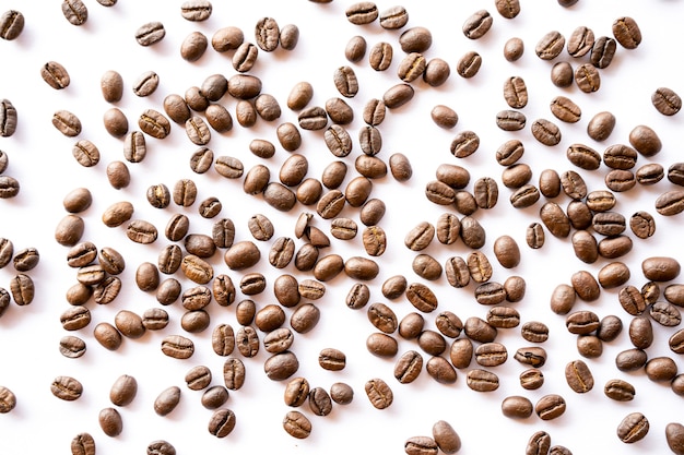 Roasted coffee beans arrange on white background