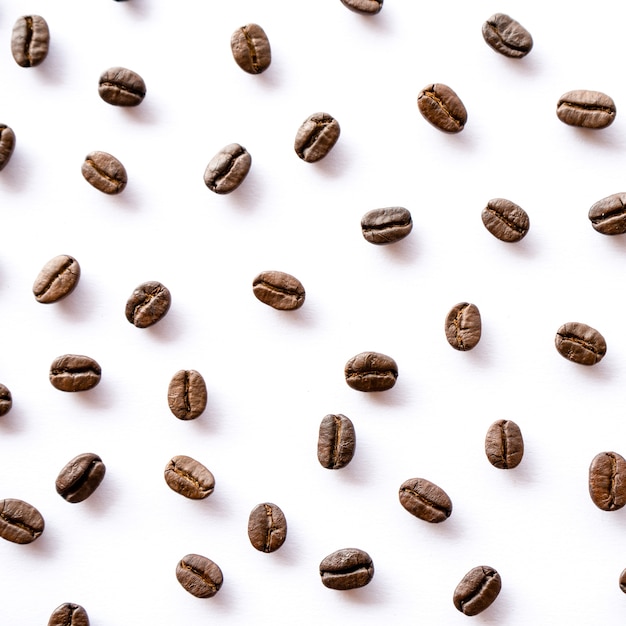 Roasted coffee beans arrange on white wall