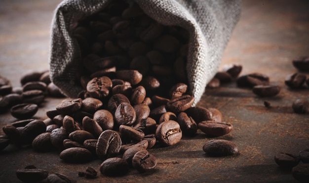 Roasted coffee beans in a bag closeup background