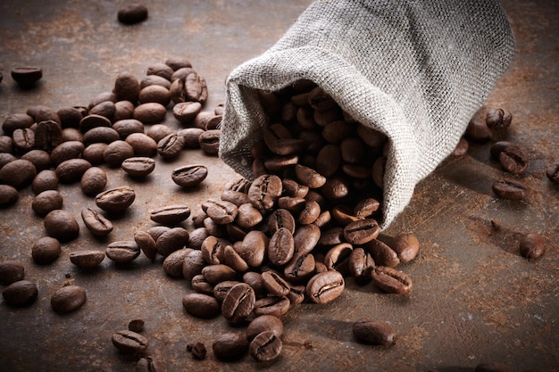 Roasted coffee beans in a bag closeup background