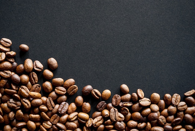 Roasted coffee beans on black background