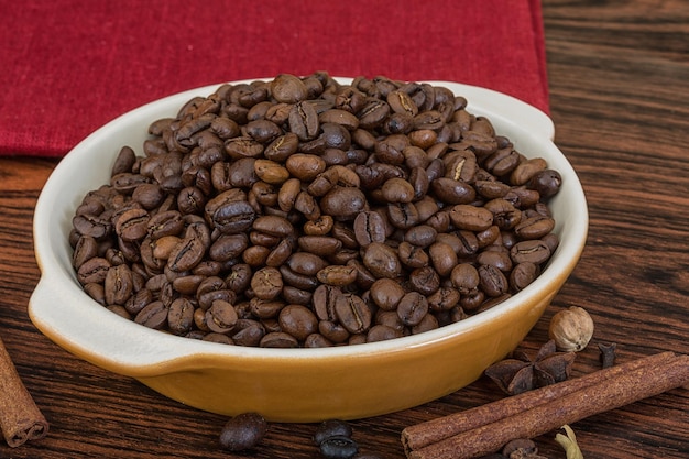 Roasted coffee beans in the bowl with cinamon