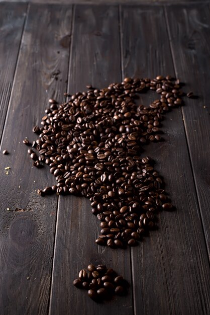 Roasted coffee beans, can be used on a wooden dark background