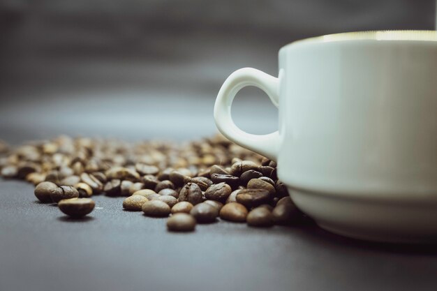 Roasted coffee beans and coffee cup