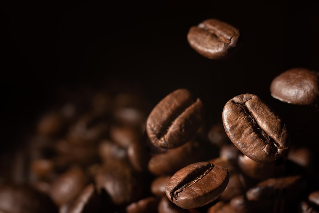 Roasted coffee beans on grey background, closeup