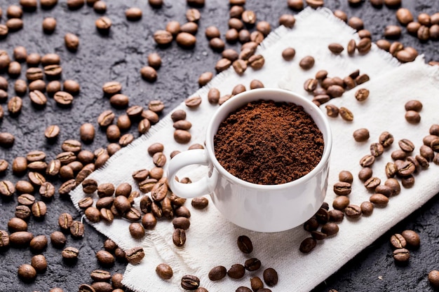 Roasted coffee beans and ground coffee on dark background\
closeup image space for text