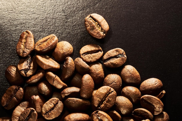 Roasted coffee beans isolated close up on black background clipping path