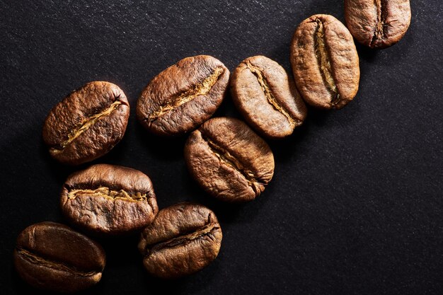 Roasted coffee beans isolated close up on black background clipping path