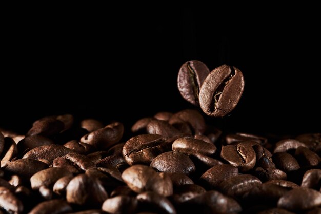 Roasted coffee beans isolated close up on black background clipping path