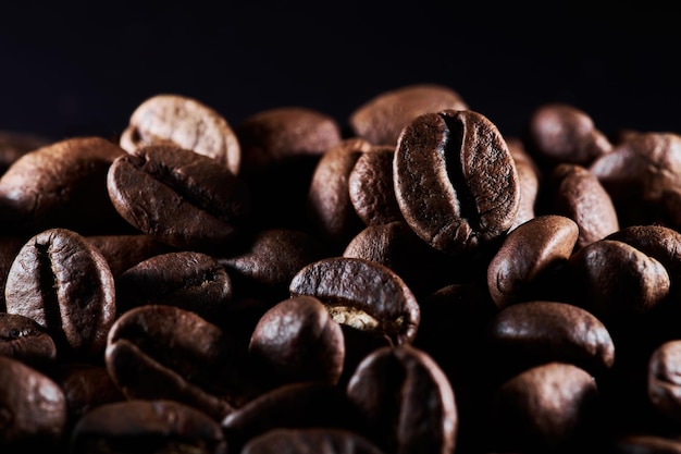 Roasted coffee beans isolated close up on black background clipping path