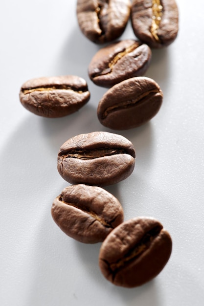 Roasted coffee beans isolated close up on white background clipping path