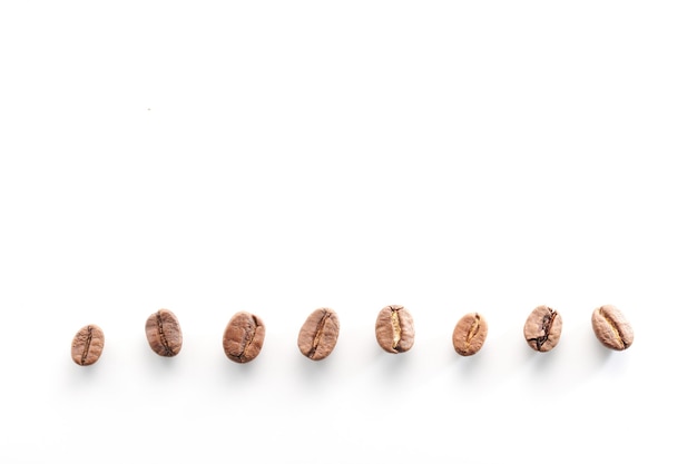 Roasted coffee beans isolated close up on white background clipping path