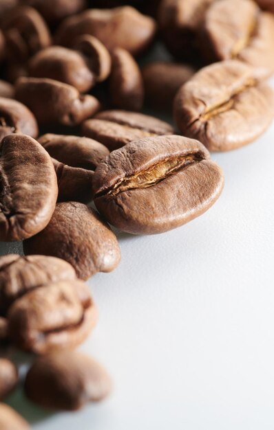 Roasted coffee beans isolated close up on white background clipping path