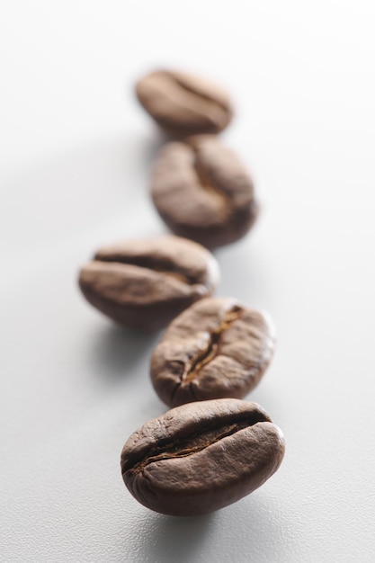 Roasted coffee beans isolated close up on white background clipping path