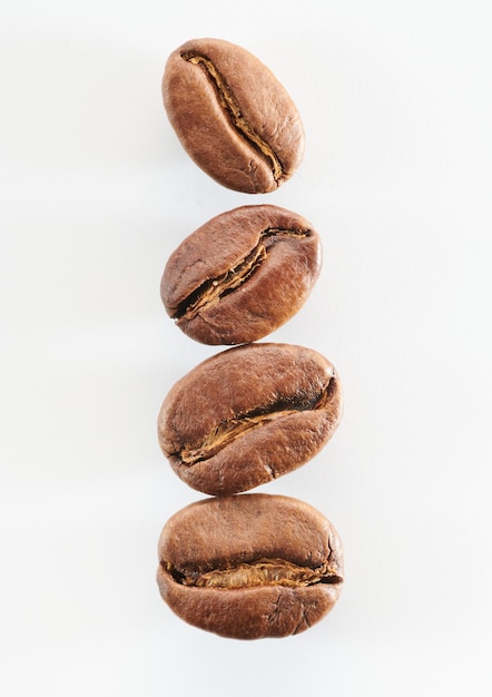 Roasted coffee beans isolated close up on white background clipping path