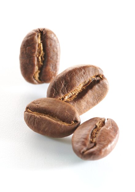 Roasted coffee beans isolated close up on white background clipping path