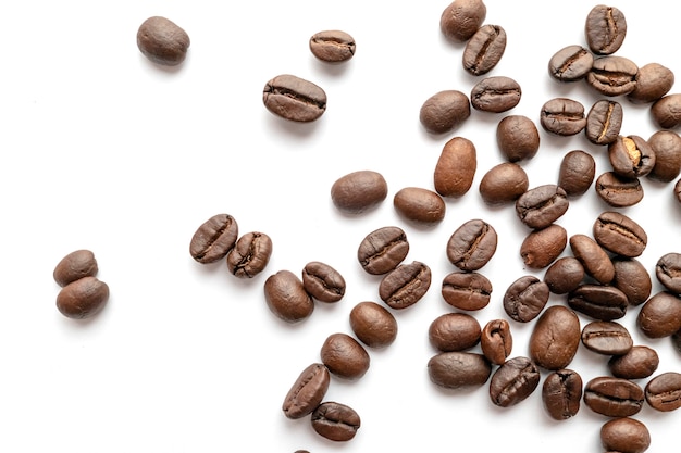 Roasted coffee beans isolated on white background. Close-up.