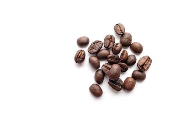 Roasted coffee beans isolated on white background. Close-up.