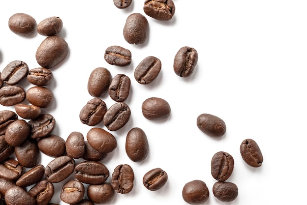 Roasted coffee beans isolated on white background. Close-up.