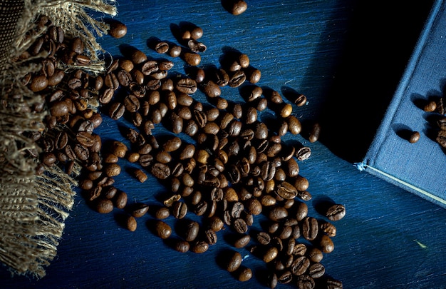 Roasted coffee beans on a navy blue background