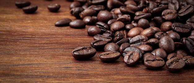 Roasted coffee beans on old wooden table