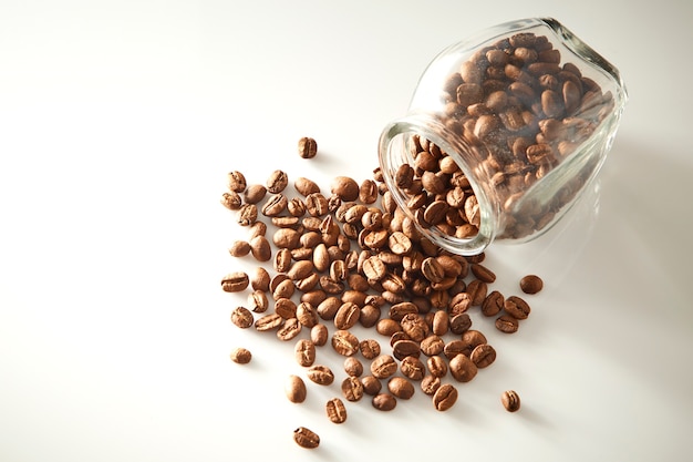 roasted coffee beans poured from clear glass