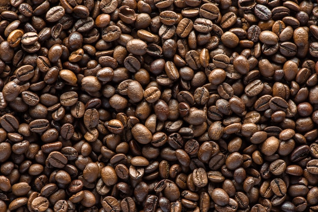 Roasted coffee beans on texture background