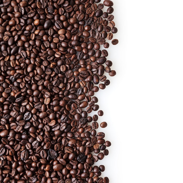 Roasted coffee beans on white background with copy space