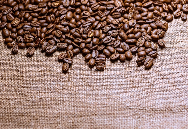 Roasted coffee beans with burlap background