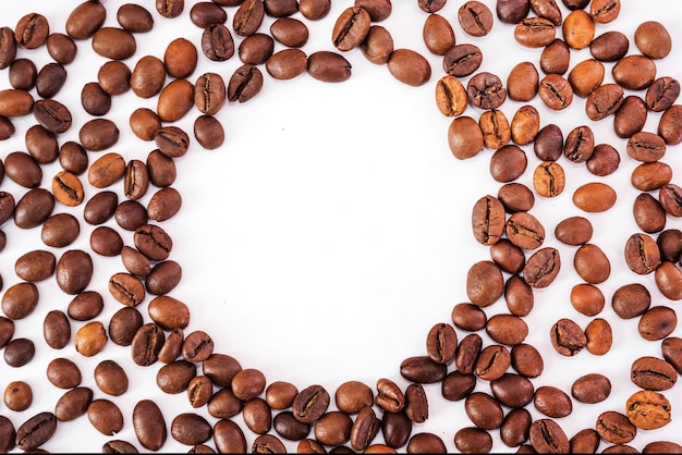 Roasted coffee beans with copy space on white background