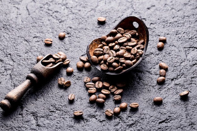 Roasted coffee beans with wooden spoon closeup image space for text