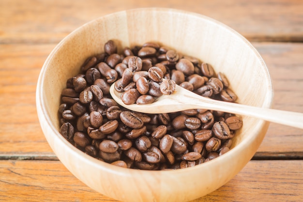 Roasted coffee beans in wooden bowl