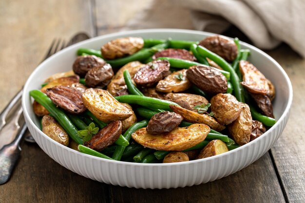 Roasted crispy fingerling potatoes with green beans n a serving bowl