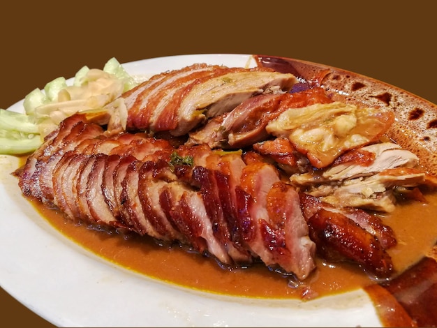 Roasted duck and grilled pork isolate on brown background