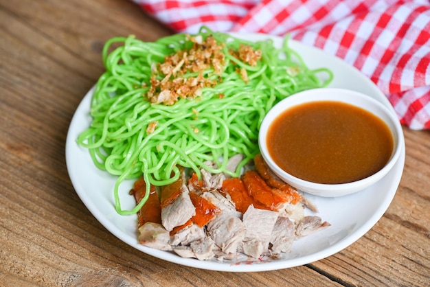 Roasted duck with jade noodle on white plate and duck sauce green noodles Chinese food Jade noodle Asian Thailand food