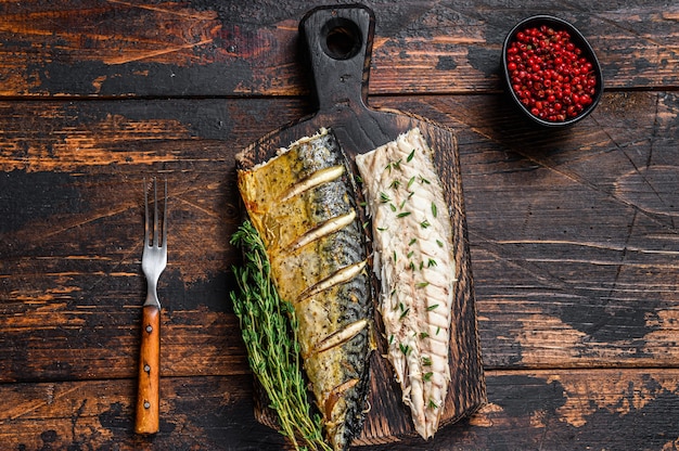 Roasted fillets of mackerel fish on cutting board. 