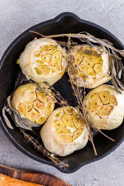 Roasted garlic spread recipe made with spices in cast iron skillet.