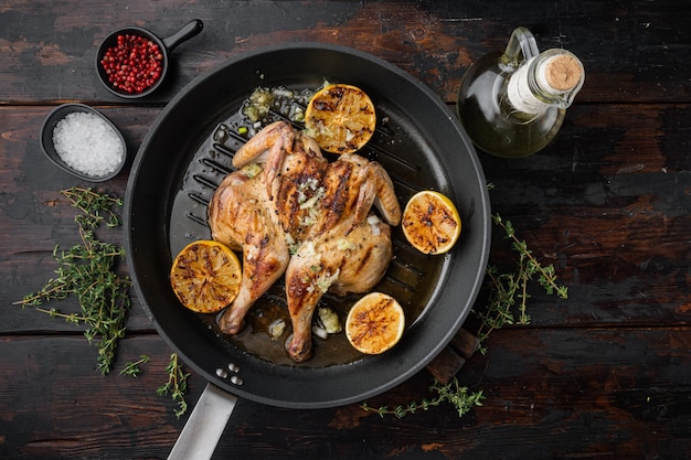 Roasted golden chicken, on old wooden table, top view