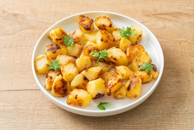 Roasted or grilled potatoes  on white plate