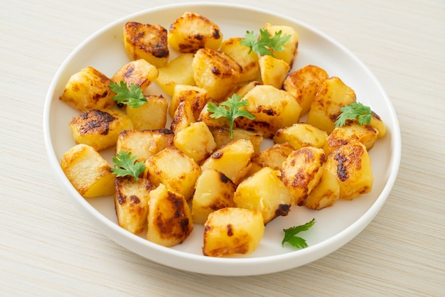 Roasted or grilled potatoes  on white plate