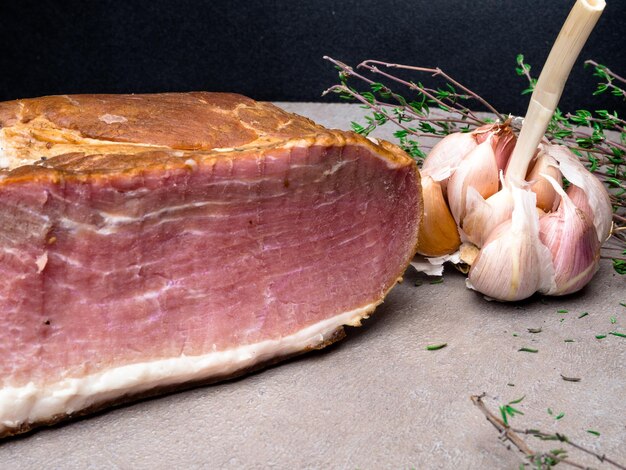 Roasted ham with fresh thyme garlic background