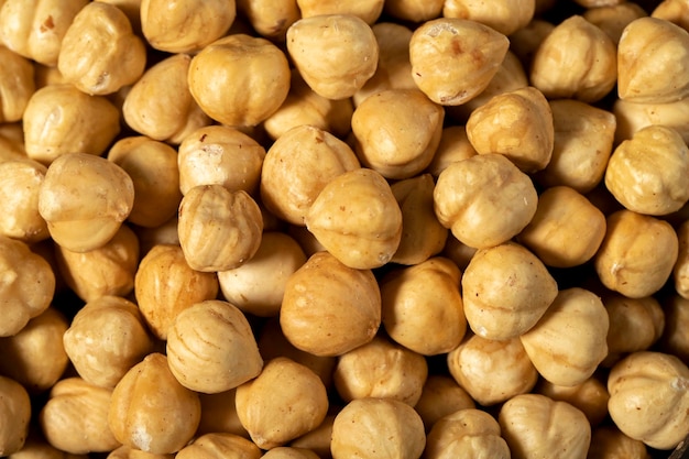 Roasted hazelnut nuts on dark background Many delicious nuts as background Studio shoot Top view