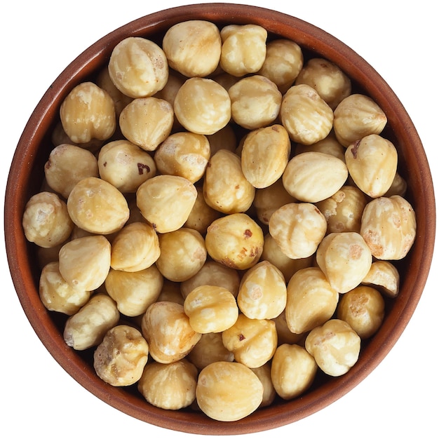 Roasted hazelnuts in a brown ceramic bowl Isolated closeup photo of food