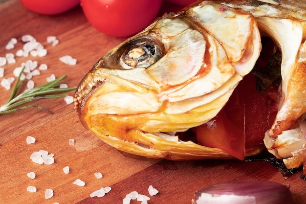 Roasted head fish on cutting board Selective focus